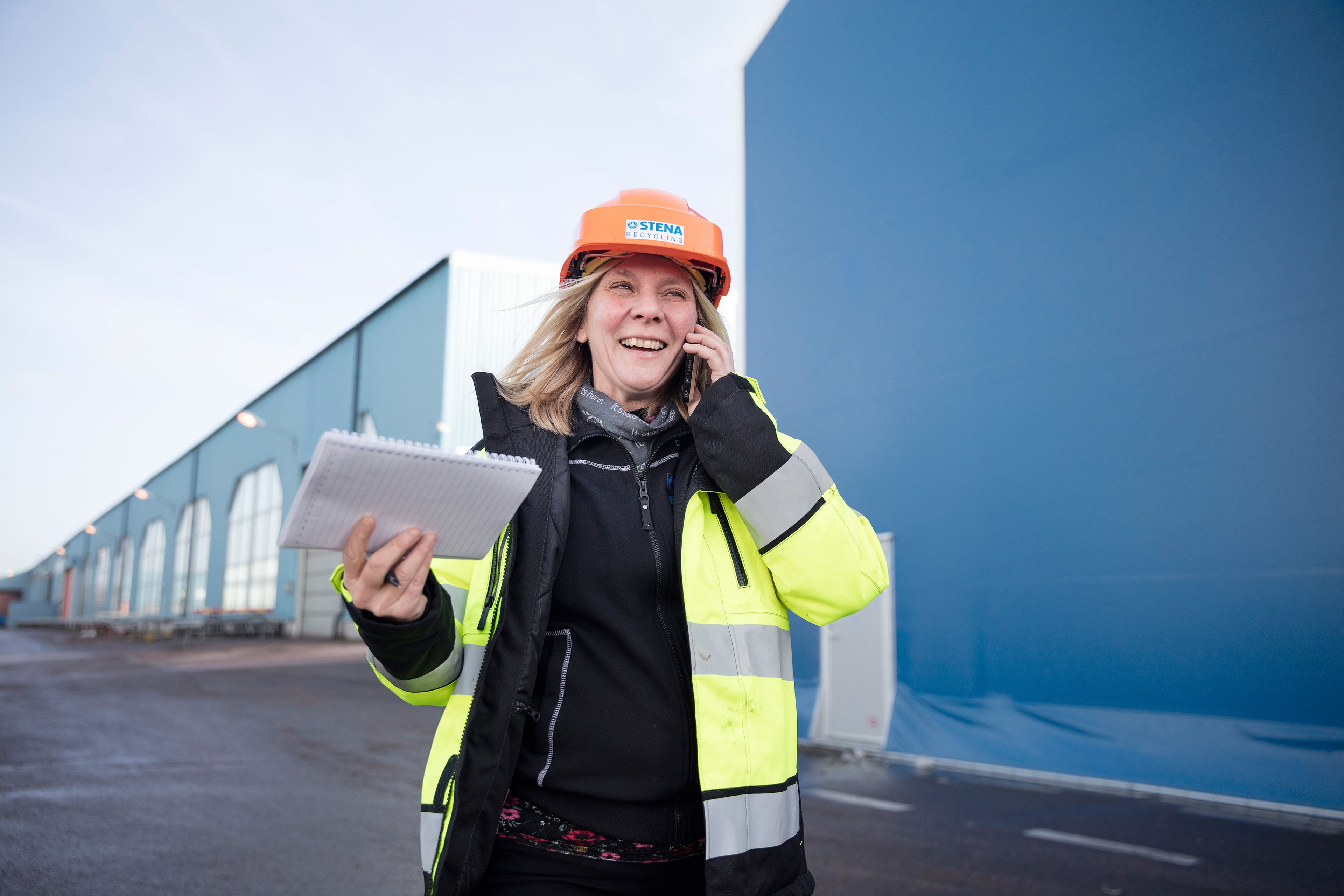 Woman with construction helmpet on the phone