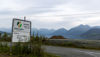 A sign with mountains behind