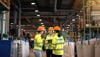 A group of three Stena Recycling Group employees talk at Stena Nordic Recycling Center, Halmstad, Sweden.