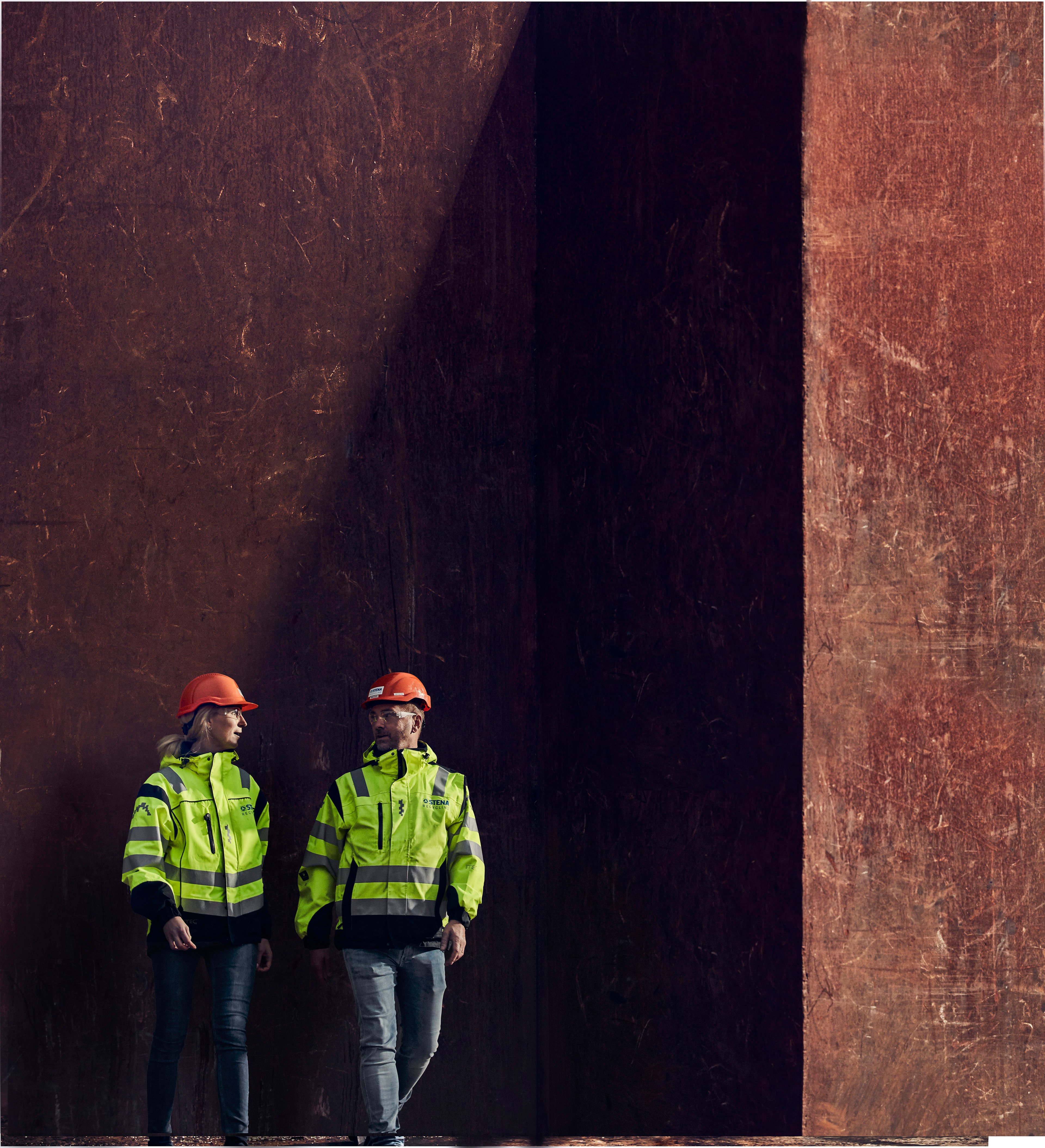 Two Stena Recycling experts - one male and one female - in hi-vis protective clothing