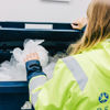 Stena Recycling employee placing plastic in a container.