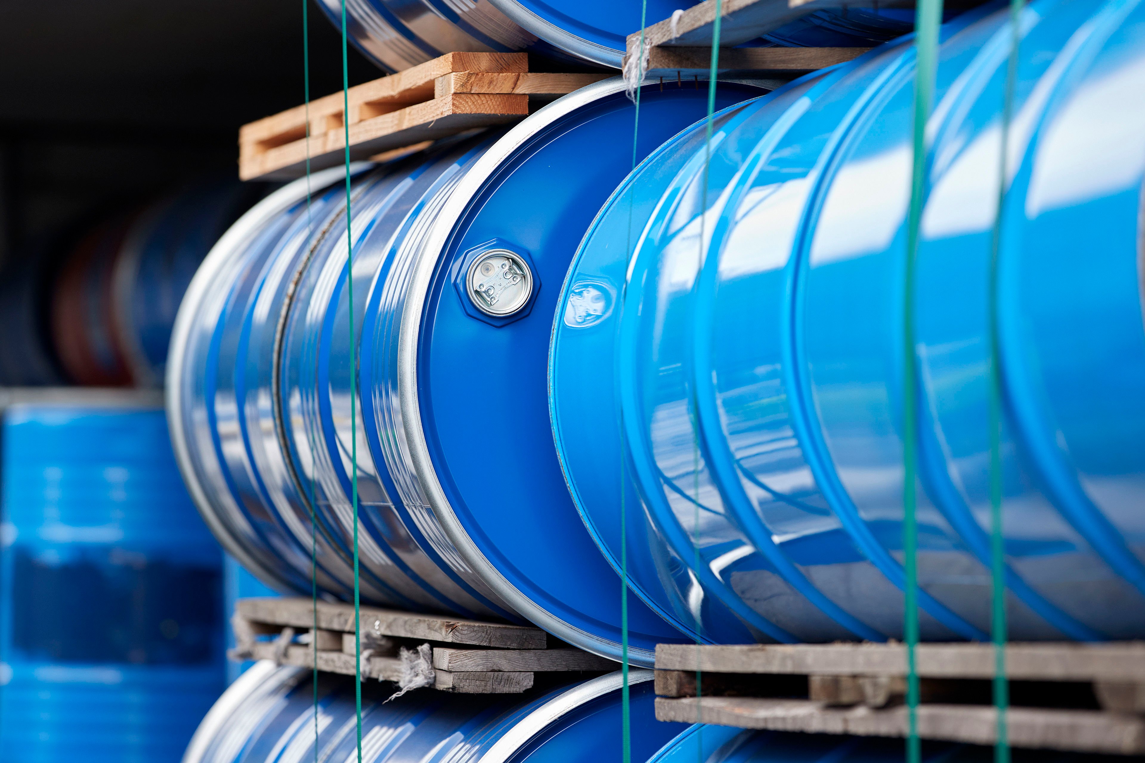 Two blue steel barrels containing hazardous waste for recycling