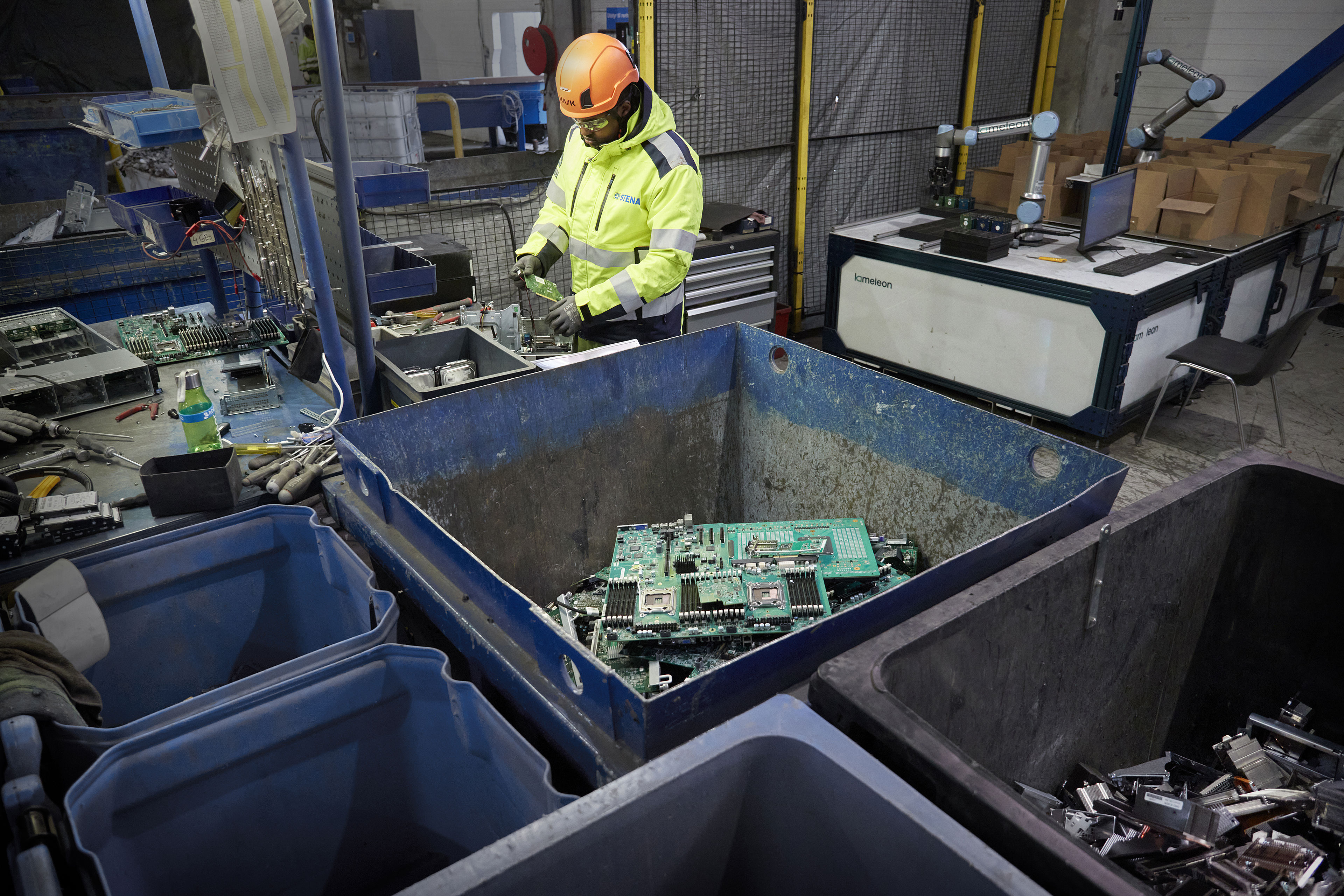 Used circuit boards safely stored in a container and ready to be recycled.