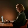 Woman working on a laptop.