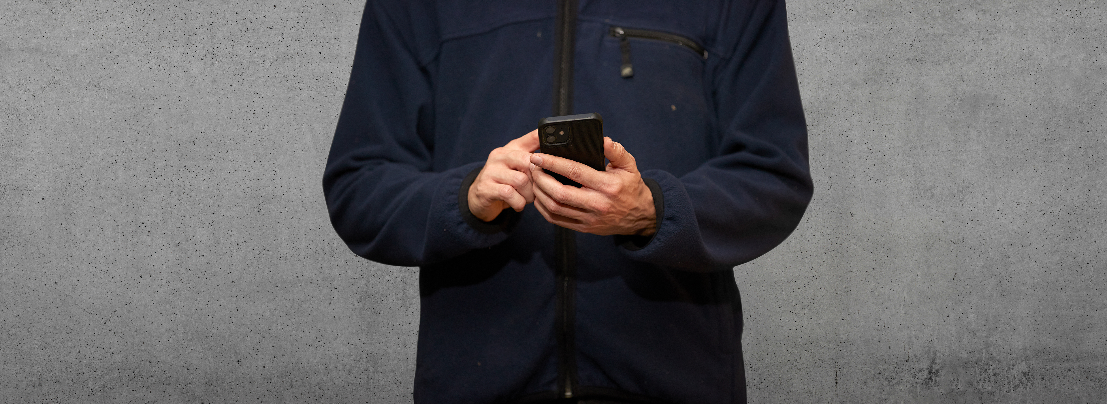 A male employee works in an office environment.